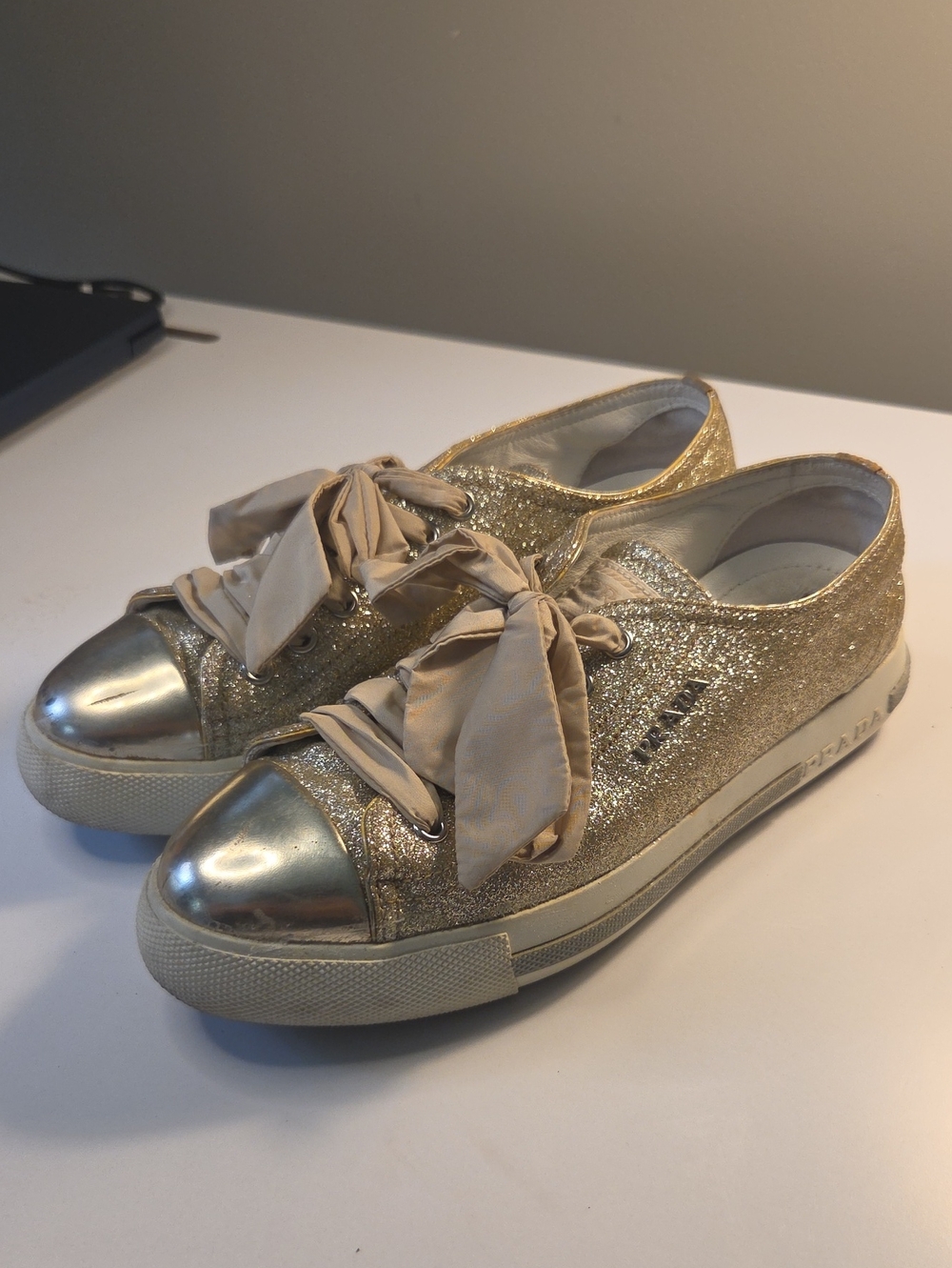Prada Sport gold glitter low-top sneakers featuring metallic cap toes 36